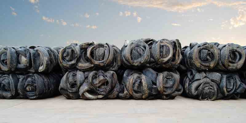 Baled rubber tyres in a row ready for recycling.